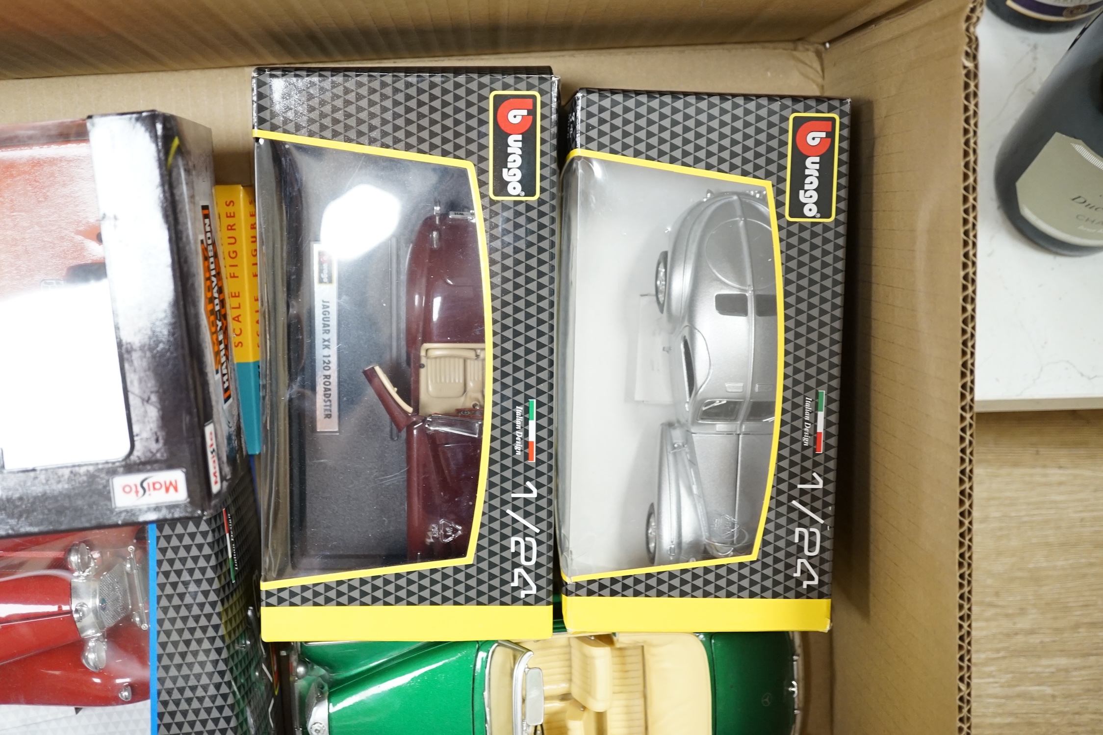 A quantity of diecast vehicles, including Burago, Harley Davidson, Maisto, etc. Condition - varies